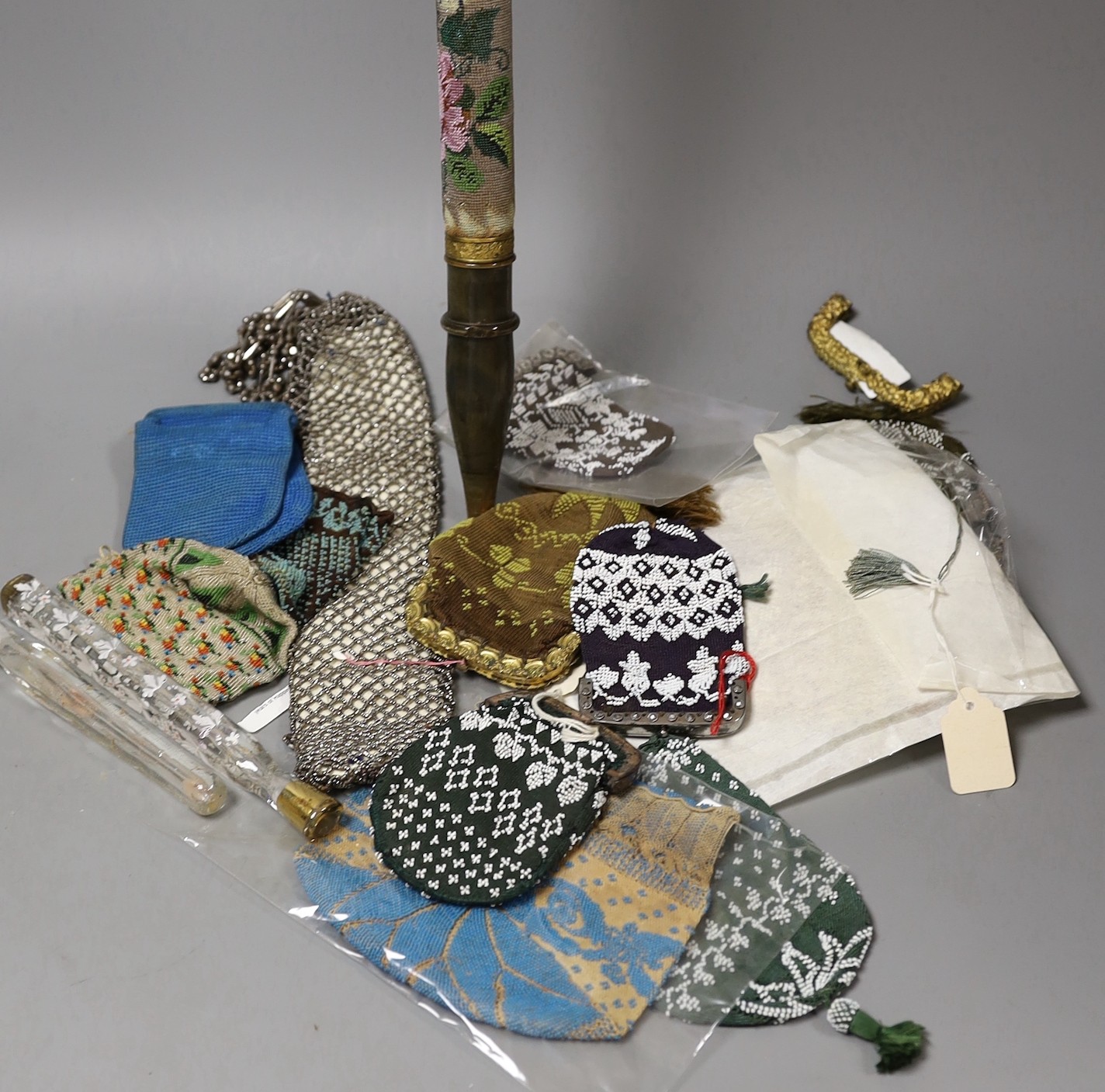 A group of mixed 19th century beadwork, cut steel and knitted purses, misers purses and reticules, together with two glass scent bottles and possibly the base to a walking stick covered with Berlin beadwork dated1832, wi